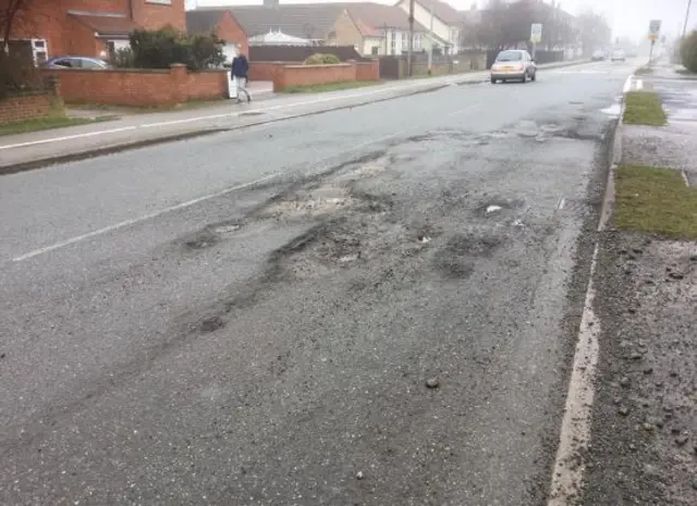 Potholes on a road.