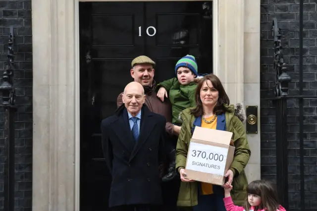 Family with Sir Patrick Stewart on step of Number 10