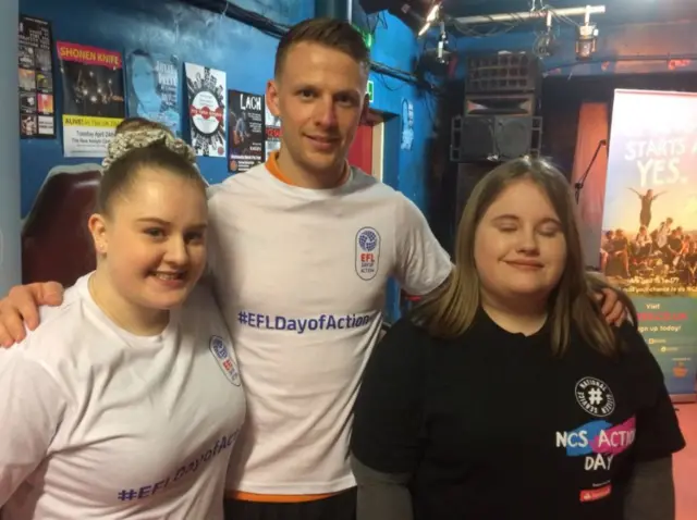 Hull City's Stephen Kingsley with two students at the Adelphi Club.