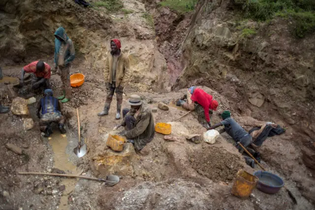 Artisanal miners sort and wash rocks to obtain cassiterite at a mining site near Numbi in eastern Democratic Republic of Congo on April 7, 2017.