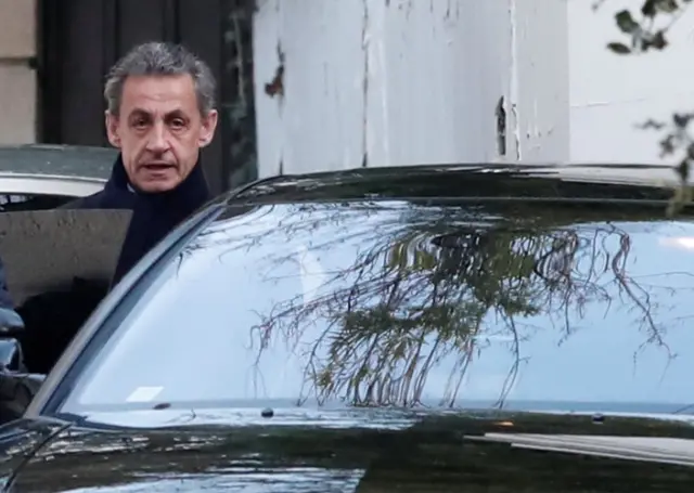 Former French President Nicolas Sarkozy enters his car as he leaves his house in Paris, France, March 21, 2018.