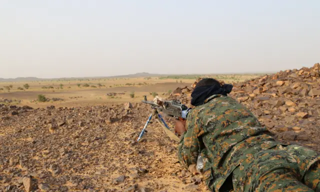 A Tuaregs fighter of the Coordination of Movements of the Azawad (CMA) points his weapon near Kidal, northern Mali on September 28, 2016,