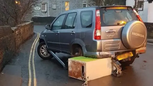 Car with cash machine under it