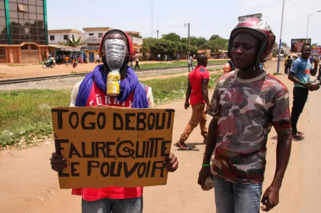 Protesters holding placards calling on President Gnassingbe to resign