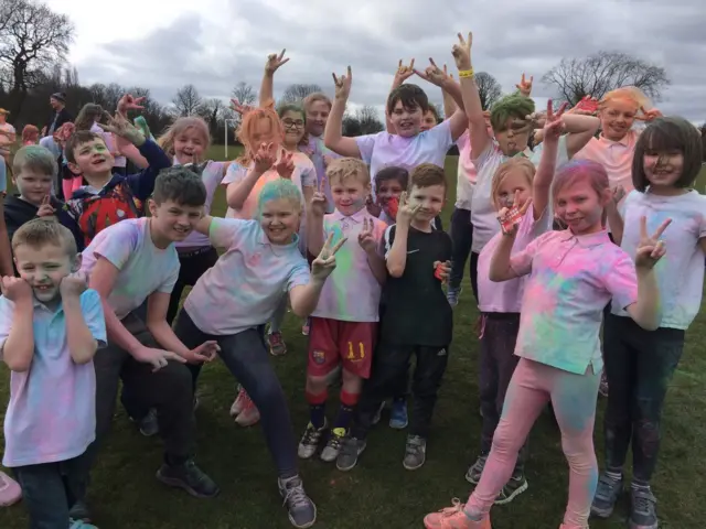 Children covered in brightly coloured powdered paint