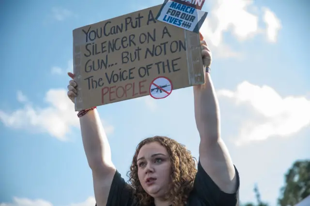 Sophie Phillips holds a sign as she attends a rally for those heading to the March for Our Lives event in Washington DC in Parkland, Florida.