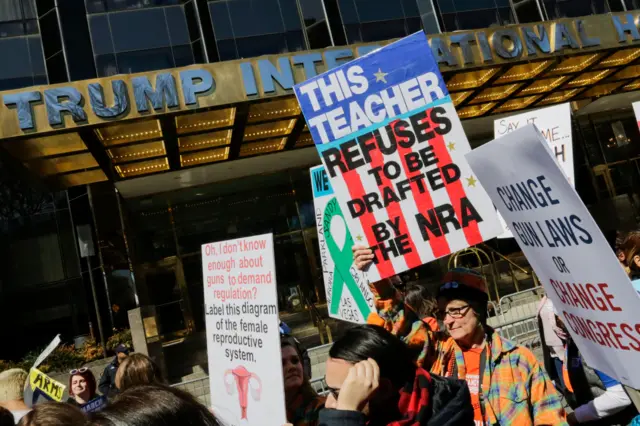 People walk by the Trump Hotel in New York