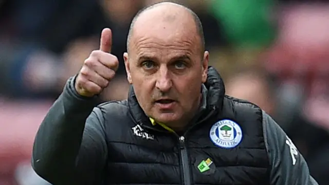 Paul Cook gives a thumbs up gesture