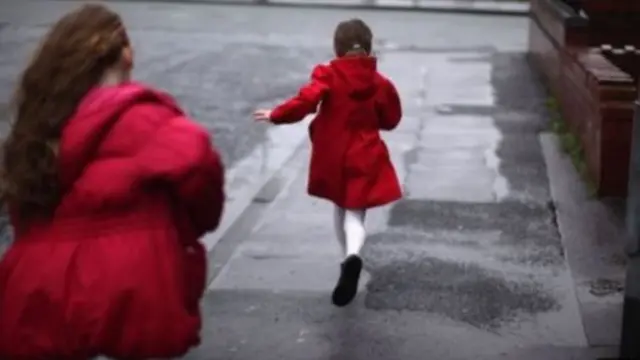 children running down a street