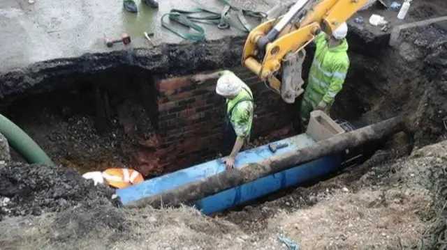 Engineers working to replace pipe