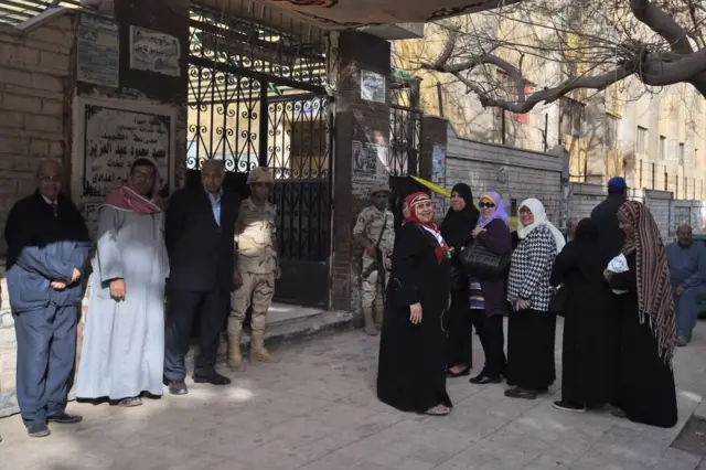 Egyptian voters queue up outside a polling station before the start of the first day of the 2018 presidential elections in Cairo.