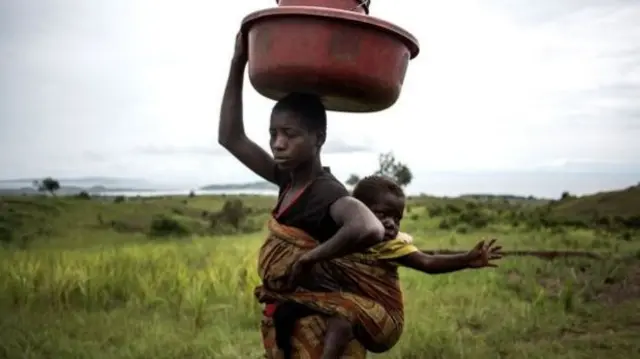 Woman carrying child