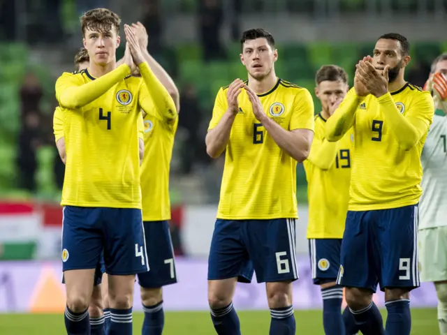 Scotland players applaud the travelling support at full-time