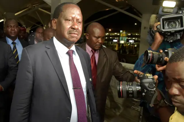 Kenya"s opposition leader Raila Odinga (L) arrives at Jomo Kenyatta International Airport (JKIA) in Nairobi early March 27, 2018,