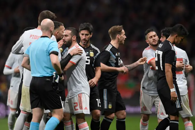 Spain and Argentina players clash during the friendly match