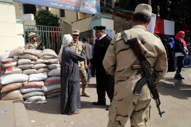 Sandbags and soldiers are seen outside a polling station