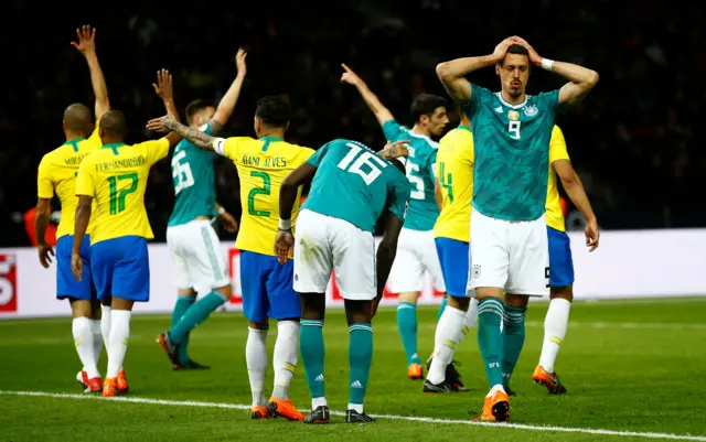 Germany players despair after a missed chance against Spain