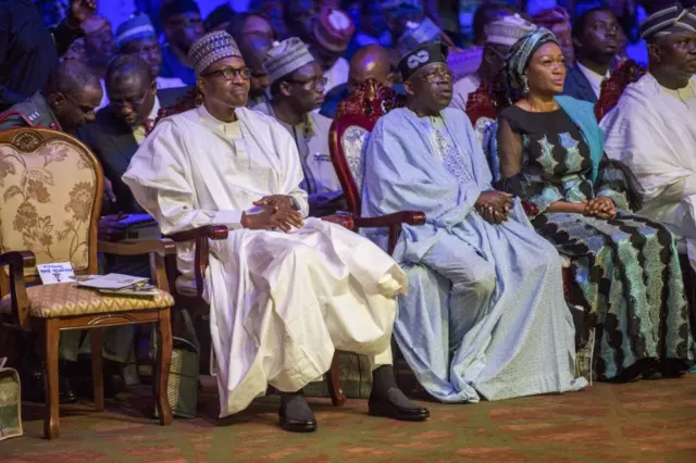 President Muhammadu Buhari (L) and Asiwaju Bola Tinubu (2ndL) attend the Bola Tinubu Colloquium at the Eko Hotel ^ Suites in Lagos, on March 29, 2018.