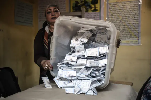 Electoral workers sort ballots to be counted in Cairo