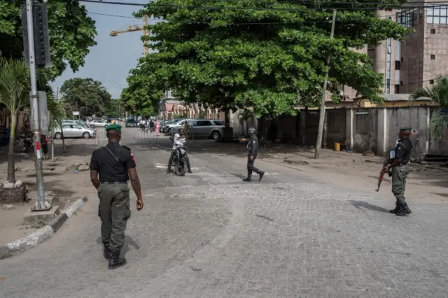 Members of the police reprimand a man on a motorcycle trying to move past a blockade in Lagos on March 29, 2018.