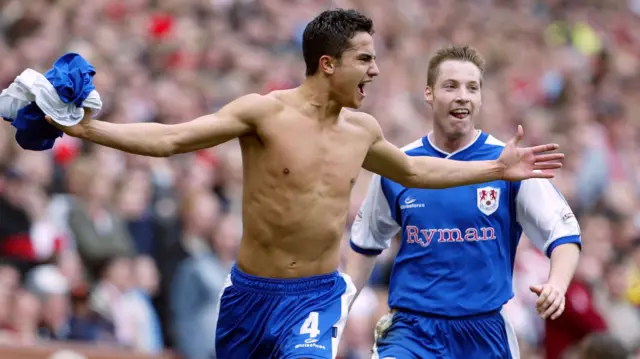 Tim Cahill and Neil Harris celebrate a goal against Sunderland