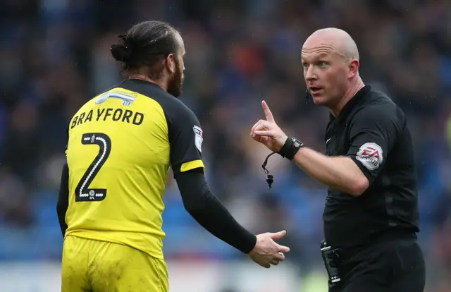 John Brayford speaks to the referee