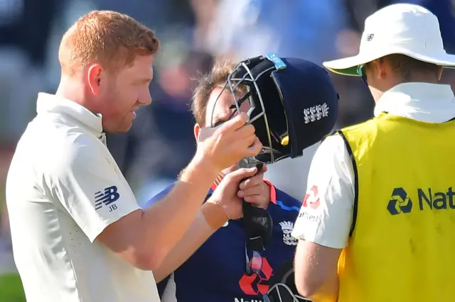 Jonny Bairstow inspects his helmet