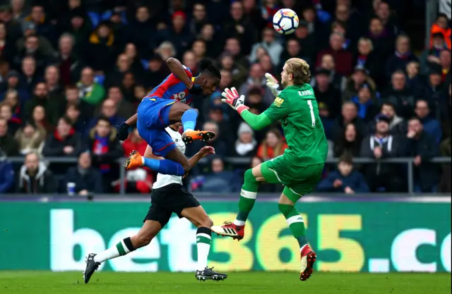 Loris Karius fouls Wilfried Zaha