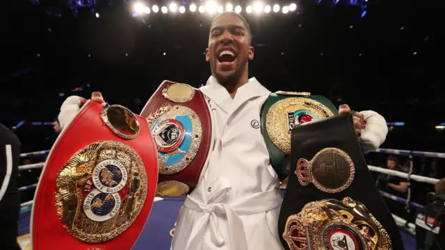 Anthony Joshua with belts