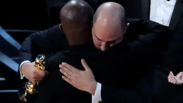 Barry Jenkins and Jordan Horowitz embrace after the mistake last year