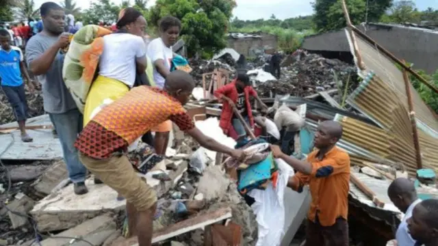 A picture of people on the dump clearing the rubble