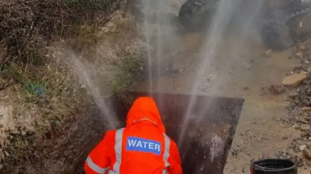 A Severn Trent worker with a burst pipe