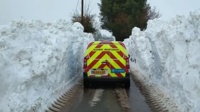 High snow drifts alongside a road