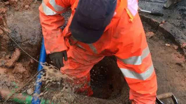 Severn Trent worker with burst pipe