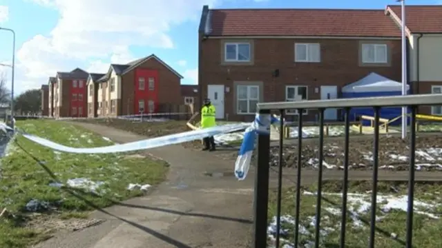 The house on Milldane surrounded by police and police tape.