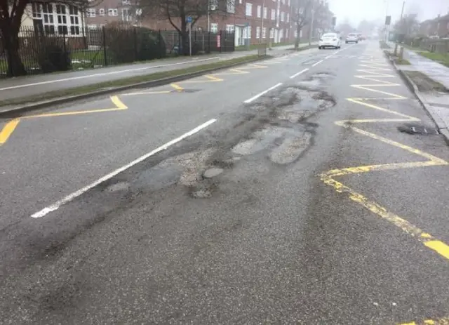 More potholes on a road.