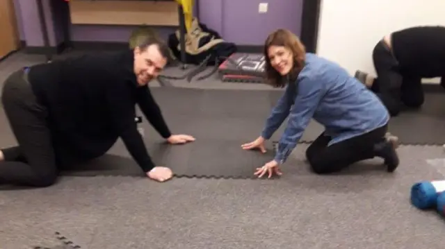 Volunteers lay soft flooring