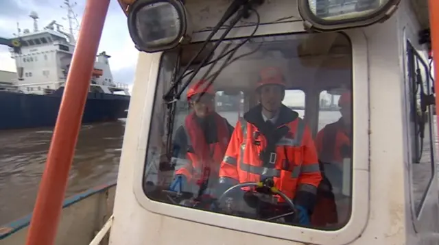 Man piloting a boat.