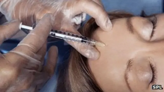 Woman having an injection into her forehead.