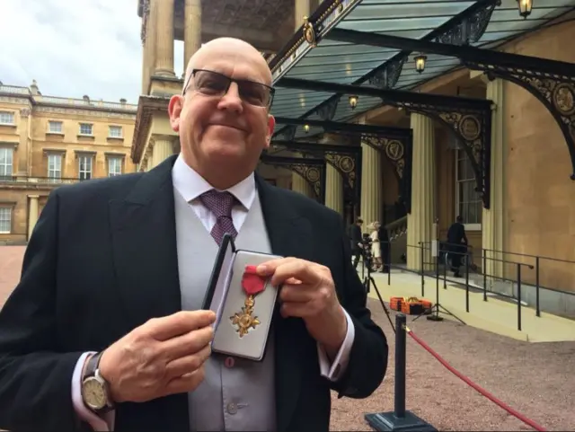 John Godber proudly showing off hos medal.