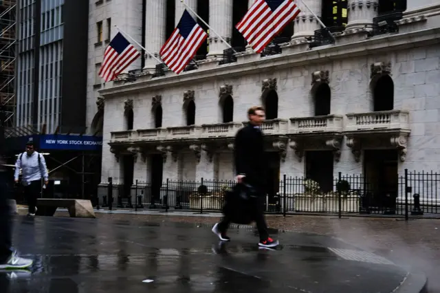 Man walks past New York Stock Exchange