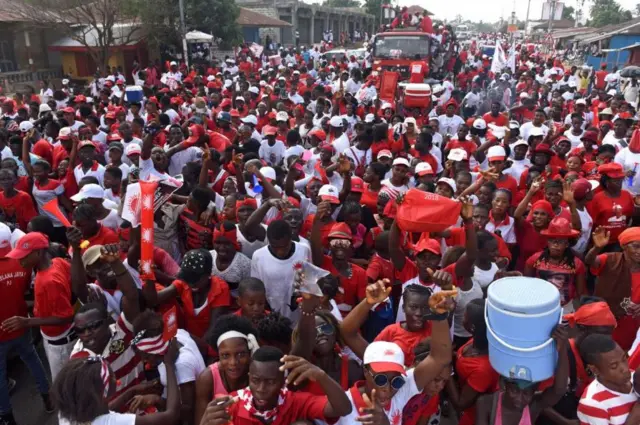 A crowd of people attending a campaign rally