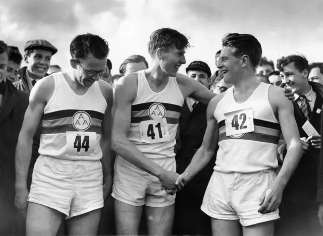 Roger Bannister (centre) being congratulated by Chris Chataway after setting a new record of 3 minutes 59.4 seconds