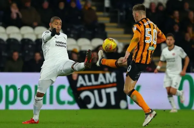 Leon Clarke of Sheffield United (L) and Angus MacDonald of Hull City (R) in action during the Sky Bet Championship match between Hull City and Sheffield United at KCOM Stadium on February 23, 2018 in Hull, England.