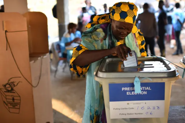 A women cast her ballot as part of the general elections, on March 7 at a polling station in Freetown. More than 3.1 million voters are registered for the polls across the small West African nation