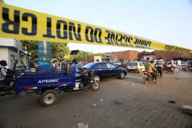 People drive by a sealed off area around the army headquarters after an alleged terrorist attacks in the capital Ouagadougou, Burkina Faso, 03 March 2018