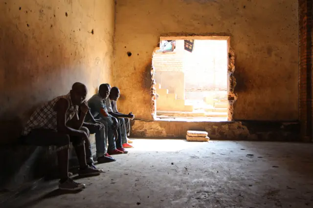 Rwandans sit in the Gikondo transit center in Kigali on September 24, 2015.