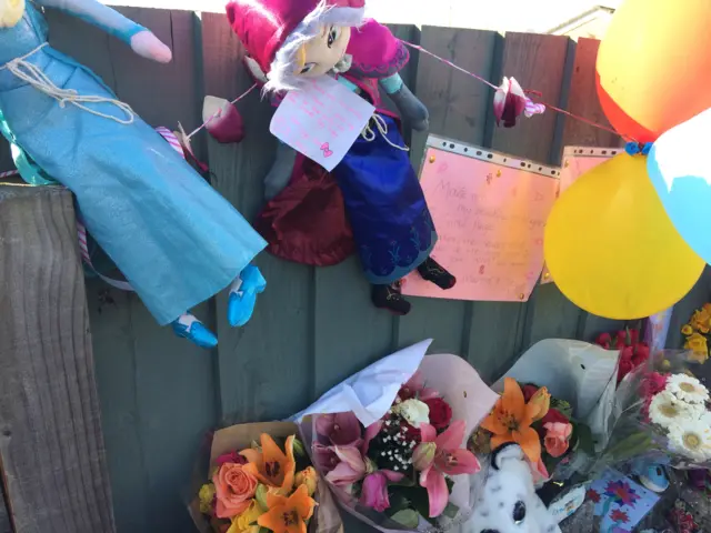 Flowers and other items left in tribute