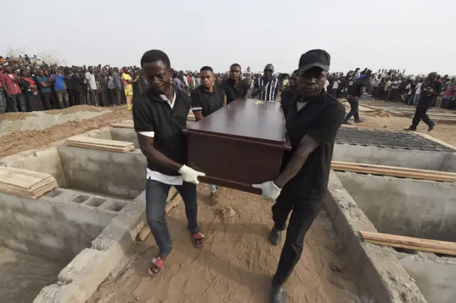 Pall bearers carry coffins during the funeral service for people killed during clashes between cattle herders and farmers, on January 11, 2018, in Ibrahim Babangida Square in the Benue state capital Makurdi.