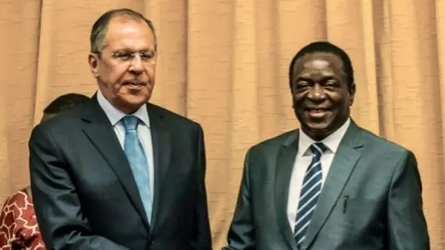 Russia"s Foreign Minister Sergei Lavrov (L) shakes hands with Zimbabwe"s President Emmerson Mnangagwa (R) at his Munhumutapa Offices in Harare on March 8, 2018.